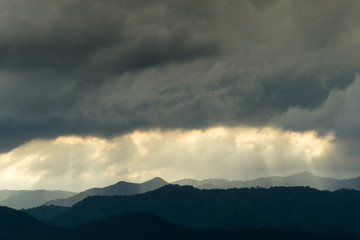 The raining clouds over the layers of the mountain.