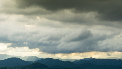 The raining clouds over the layers of the mountain.