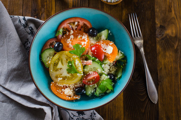 Tabbouleh salad on dark wooden background