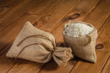 Fototapeta na wymiar Rice in bags on a wooden table