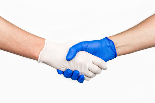 Handshake with blue and white medical gloves, profile view on white background.