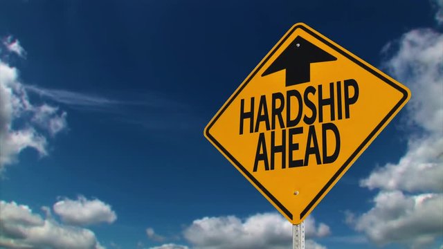 A road sign warns of hardship ahead.	 	