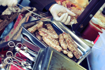 Cooking meat sausages on the grill