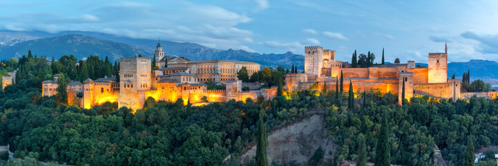 Panorama of Moorish palace and fortress complex Alhambra with Comares Tower, Alcazaba, Palacios Nazaries and Palace of Charles V during evening blue hour in Granada, Andalusia, Spain - obrazy, fototapety, plakaty