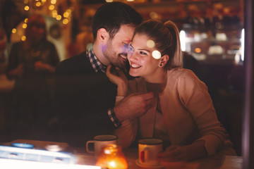 Couple dating at night in pub