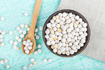 chickpeas in a bowl on a wooden background
