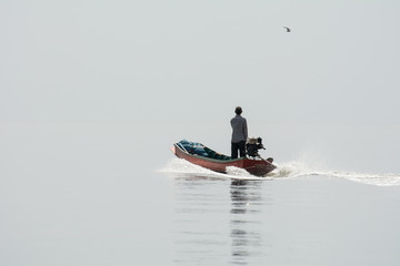 NOV 5,2016 : The fisherman sailing at Bangpakong river in Chachengsao Provice east of Thailand.(on white background)