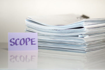 Scope; Stack of Documents on white desk and Background.