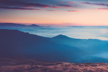 Obraz na płótnie Canvas Foggy mountains at sunrise.
