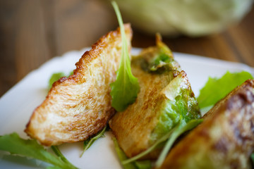 cabbage pieces fried in batter with salad