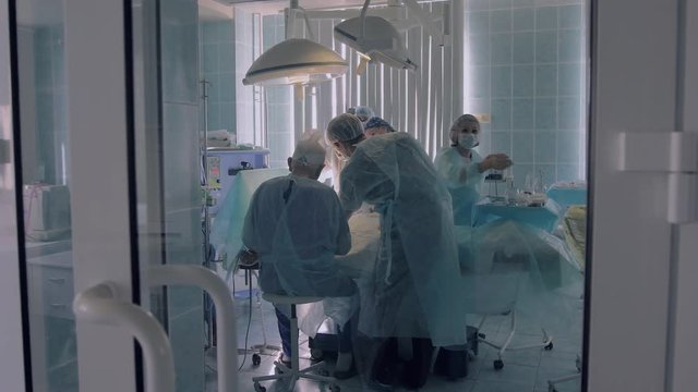 Hospital Medical Team Performing Surgery In Operating Room
