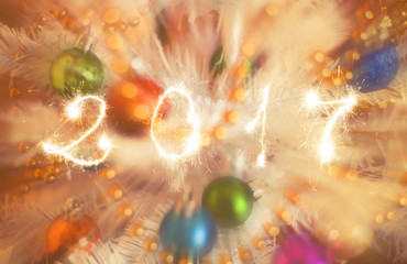 Obraz na płótnie Canvas Happy new year 2017 writing sparkles firework with christmas defocused light bokeh background