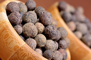  Bowls with allspice on brown background