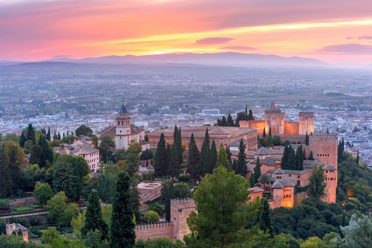 Palace and fortress complex Alhambra with Iglesia de Santa Maria, Palacios Nazaries and Alcazaba during sunset in Granada, Andalusia, Spain