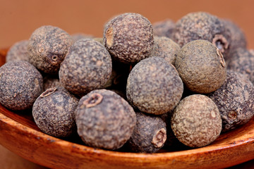 Allspice in a wooden spoon