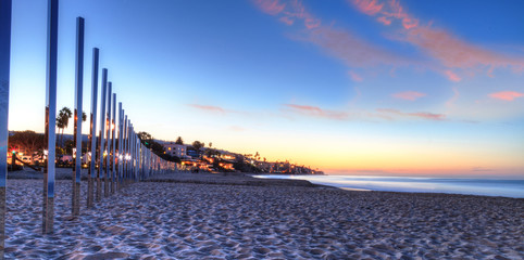 Sunrise over art titled One Forth Mile Arc by artist Phillip K. Smith  III stretches across Main...