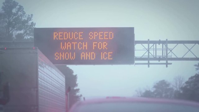 Extreme weather sign, stuck in snow storm on a highway