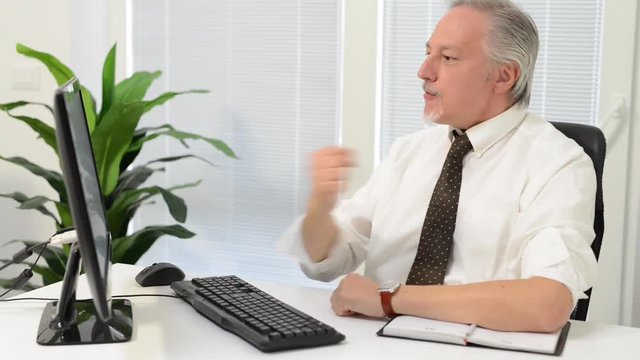     Very happy businessman looking at his computer monitor 