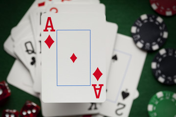 Obraz premium Playing cards, poker chips, and dices on green table