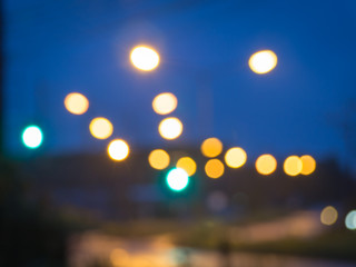 Lights blurred bokeh background from road side at night time.