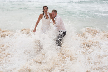 Happy lovely couple having fun in the ocean