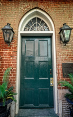 Fototapeta na wymiar Green Door with Two Gas Lamps in the French Quarter New Orleans