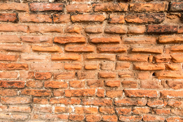 old brick wall with crumbling bricks