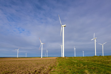 Wind turbines generating electricity surrounded by agricultural fields in Polish country side....