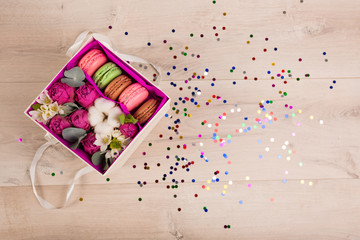 Flowers in a gift box and colorful confetti