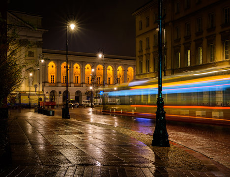A late night bus in a rainy Warsaw street