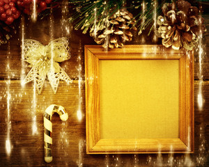 Frame with gifts on wooden background.