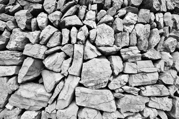 Massive large wall composed of big stones in black and white col