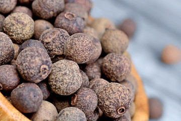 Bowl with allspice on table