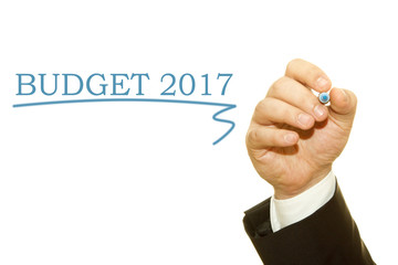 Hand writing Budget 2017 with a marker on a transparent wipe board.