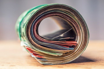 Euro banknotes. Euro currency. Euro money. Close-up Of A Rolled Euro Banknotes On concrete or...