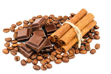 Dark chocolate bar, cubes, cinnamon sticks and coffee beans isolated on white background.