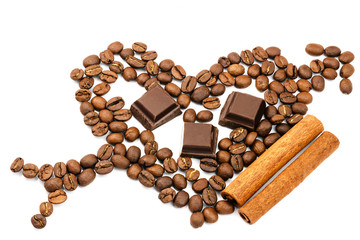 Roasted coffee beans in shape of heart with cupid arrow, chocolate cubes, cinnamon stick, isolated on white background.