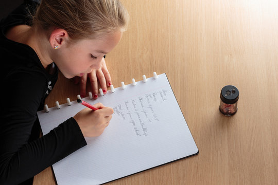 Girl Doing Homework In The Kitchen