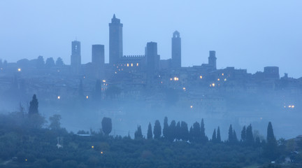 old city in blue foggy morning in Italy