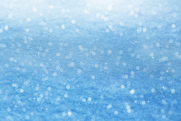 Winter background. Sparkling snow with bokeh