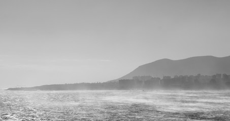 Fototapeta na wymiar Sea on the background of the city in fog