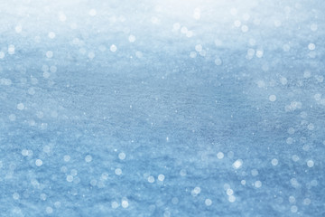 Winter background. Sparkling snow with bokeh