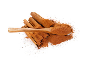 Cinnamon sticks,powder and wooden spoon isolated on white background