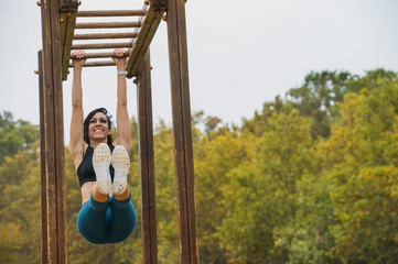Happy attractive woman doing crossfit in the park