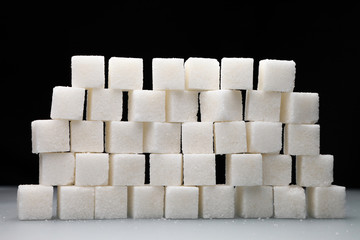 sugar cubes/ wall of sugar cubes on a black background