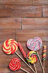 Sweet lollipops on a brown wooden table