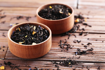 Heap of dry tea on brown wooden table