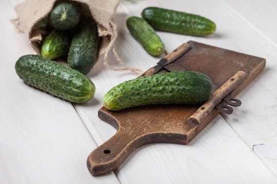Raw cucumbers on cutting board.