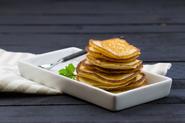 Homemade corn pancakes. Rustic style. Wooden background.