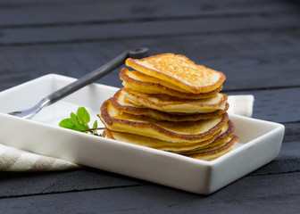 Bunch of homemade pancakes on the black wooden table